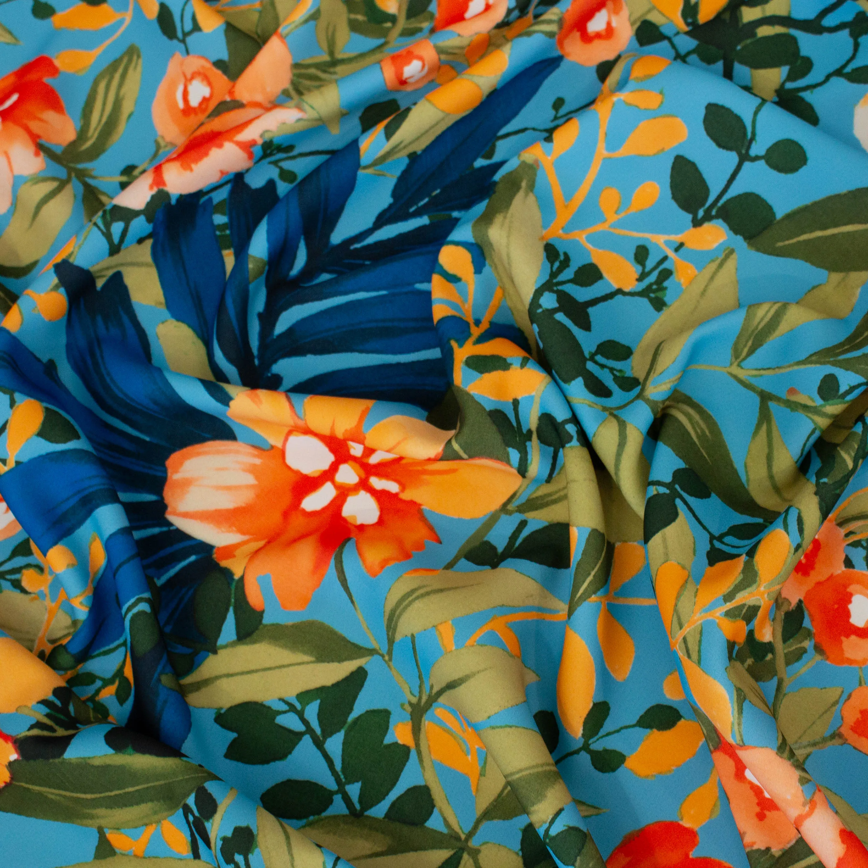 Polyester blauw met oranje bloemen
